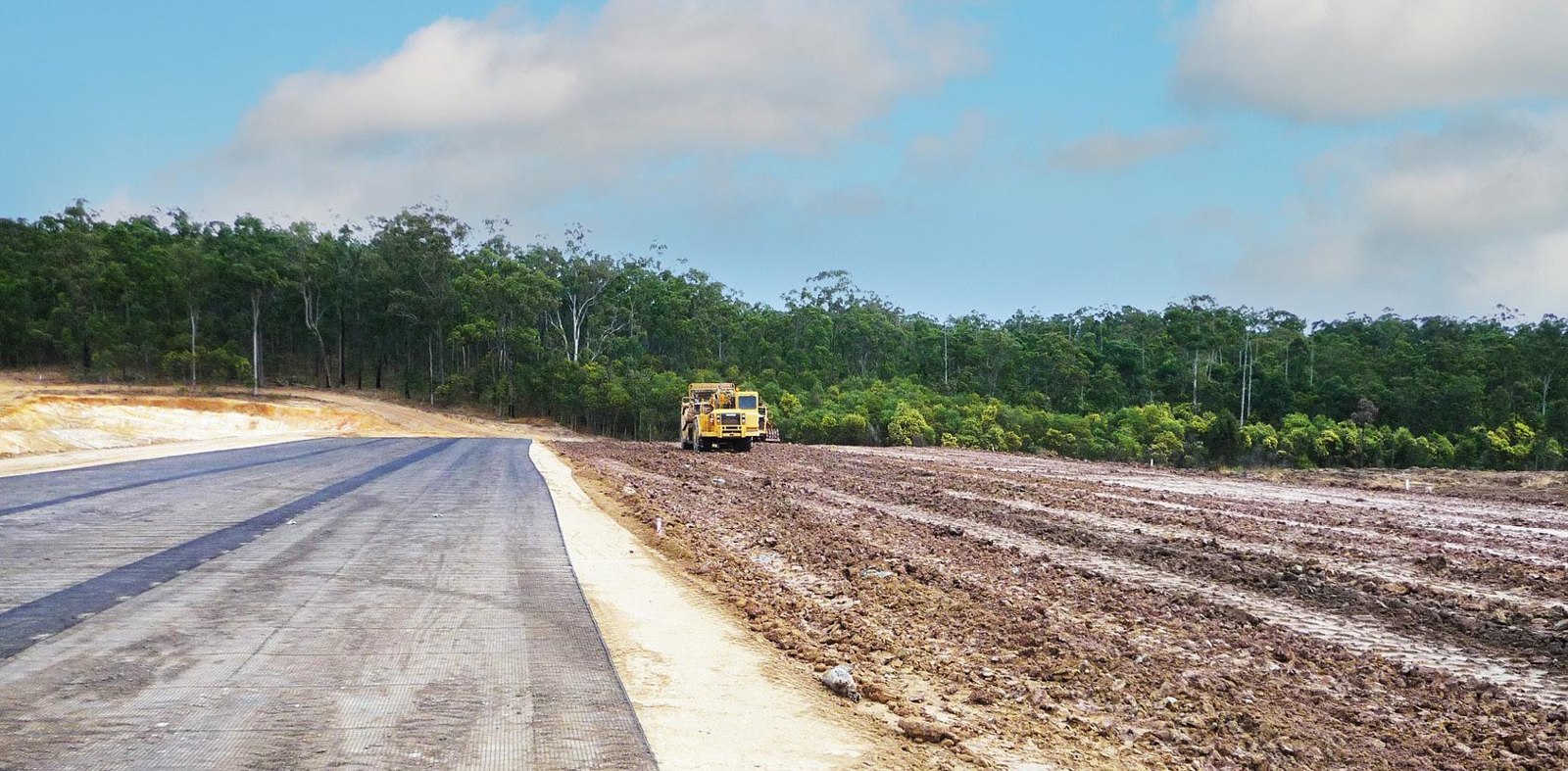 Geogrid reinforcement laid over prepared soil during earthworks