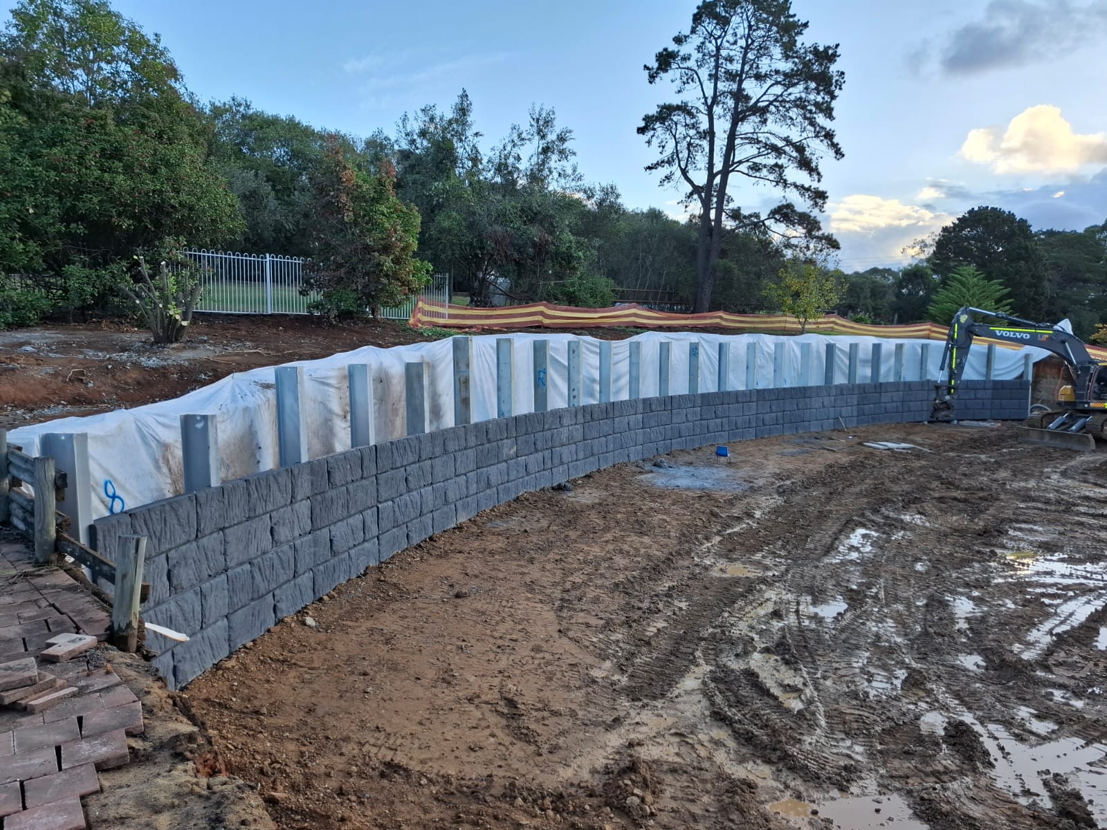 Terraced sandstone block and concrete sleeper retaining walls on a civil construction site
